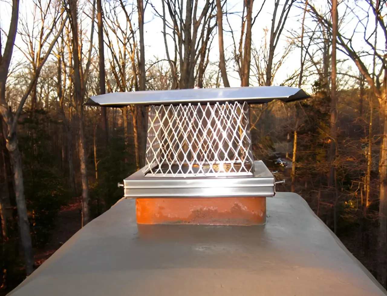A metal chimney cap sitting on top of a roof.